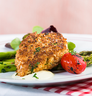 Dijon Chicken on a plate with asparagus and roast tomato