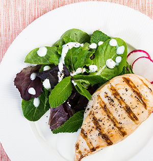Grilled Yogurt Chicken with Mint made with Astro yogurt and served along side a green leaf salad with radish