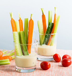 Honey Mustard Dressing made with Astro yogurt served in glasses with sliced cucumber, carrot and celery with cherry tomatoes on the side