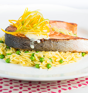 Salmon steaks in Orange-Lime Marinade made with Astro yogurt served on a bed of rice and peas