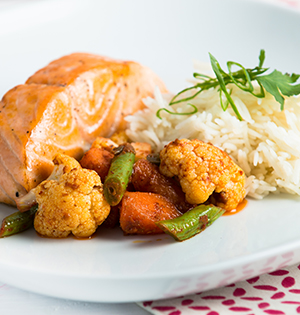 Tandoori Salmon with Biryani Vegetables and Coconut Curry Sauce made with Astro yogurt an served with rice and glazed vegetables