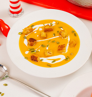 Butternut Squash Soup made with Astro yogurt served in a white bowl.